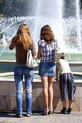 Image showing Girls and boy near fountain