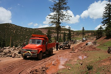 Image showing Trucks on muddy road