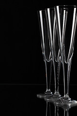 Image showing Three champagne glasses on a glass plate