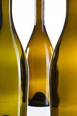 Image showing Detail of three empty wine bottles 