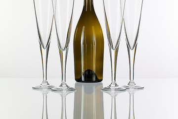 Image showing Four  champagne glasses on a glass table