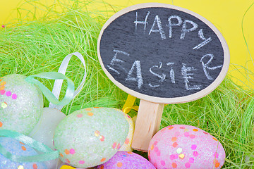 Image showing Closeup ester eggs in nest with chalkboard