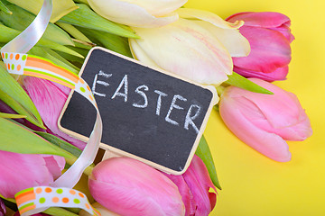 Image showing Easter ribbon, tulips and small chalkkboard