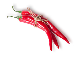 Image showing Three red chili peppers tied with a rope top view