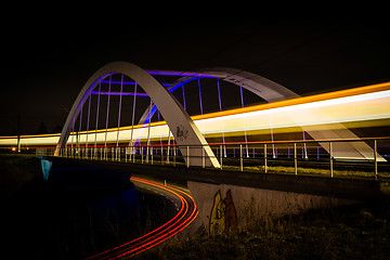 Image showing Railway bridge with train and car lights  at night