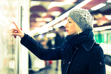 Image showing Lady looking on public transport map panel.