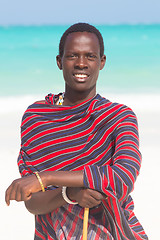 Image showing Traditonaly dressed black man on beach. 