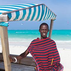 Image showing Traditonaly dressed black man on beach. 