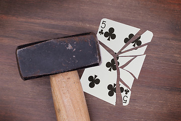 Image showing Hammer with a broken card, five of clubs