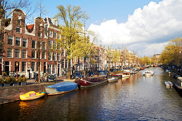 Image showing Amsterdam canal with trees and small boats