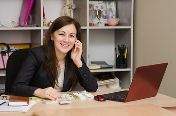 Image showing girl and office talking on phone looking into frame smiling