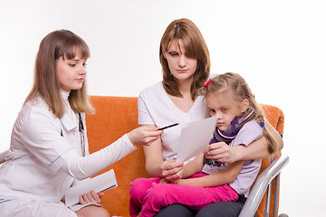 Image showing Pediatrician prescribes treatment to child and her mother explains recipe