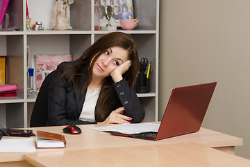 Image showing girl in office looking wistfully into monitor