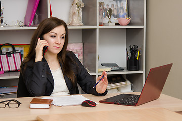 Image showing employee of office is telephone conversation with a worried expression on his face