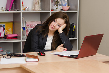 Image showing Office worker asleep at his desk