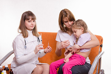 Image showing Pediatrician is going to get a shot sick child sitting on hands of mother