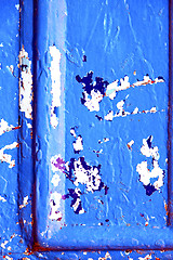 Image showing nail  paint in the blue  door and rusty 