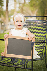 Image showing Cute Baby Girl in Chair Holding Blank Blackboard