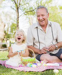 Image showing Grandfather and Granddaughter Coloring Easter Eggs on Blanket At