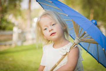 Image showing Cute Baby Girl Holding Parasol Outside At Park