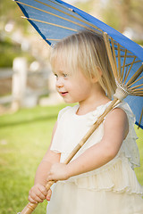 Image showing Cute Baby Girl Holding Parasol Outside At Park