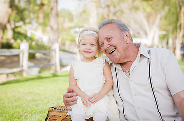 Image showing Grandfather and Granddaughter Hugging Outside At The Park