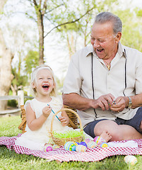 Image showing Grandfather and Granddaughter Coloring Easter Eggs on Blanket At