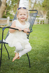 Image showing Cute Playful Baby Girl Portrait Outside at Park