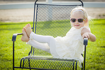 Image showing Cute Playful Baby Girl Wearing Sunglasses Outside at Park