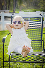 Image showing Cute Playful Baby Girl Wearing Sunglasses Outside at Park