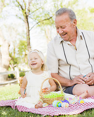 Image showing Grandfather and Granddaughter Coloring Easter Eggs on Blanket At