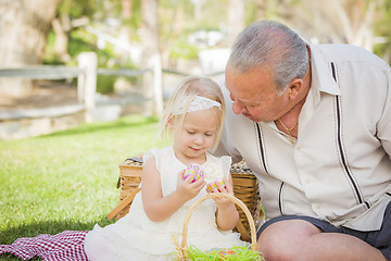 Image showing Grandfather and Granddaughter Enjoying Easter Eggs on Blanket At