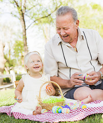 Image showing Grandfather and Granddaughter Coloring Easter Eggs on Blanket At