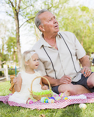 Image showing Grandfather and Granddaughter Coloring Easter Eggs on Blanket At