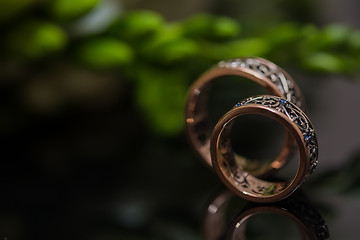 Image showing Two wedding rings in infinity sign. Love concept.