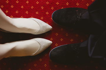 Image showing Bride's and groom's shoes on carpet.