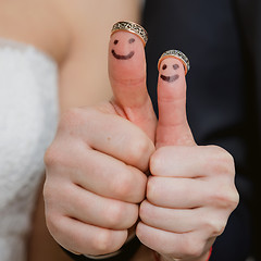 Image showing wedding rings on their fingers painted with the bride and groom, funny little people