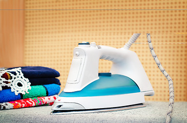 Image showing Electric iron on the Ironing Board.
