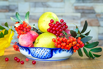 Image showing Still life: books and fruit and berries in a beautiful vase.