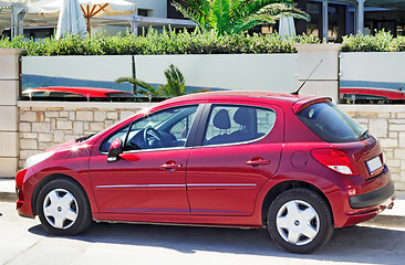 Image showing A small car in the Parking lot near the hotel.