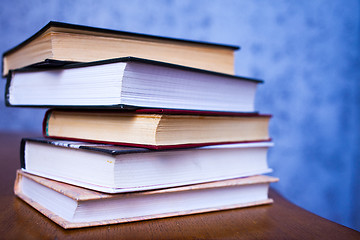 Image showing stack of book on the wooden desk