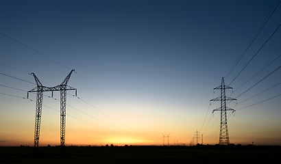 Image showing Large transmission towers at sunset