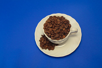 Image showing Coffee cup full of whole beans