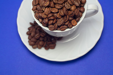 Image showing Coffee cup full of whole beans