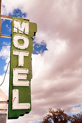 Image showing Neon Motel Sign Clear Blue Sky White Billowing Clouds