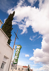 Image showing Neon Motel Sign Clear Blue Sky White Billowing Clouds