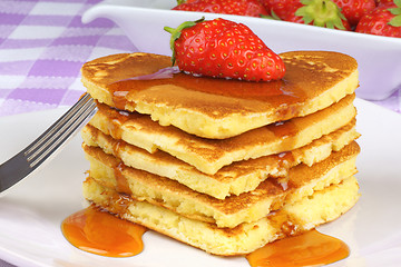 Image showing Heart-shaped pancakes with syrup and strawberry