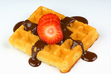 Image showing Waffle with strawberry slices and chocolate sauce