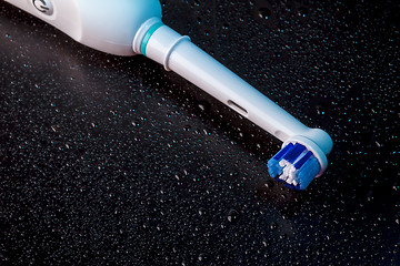 Image showing White Electric Toothbrush on Black 