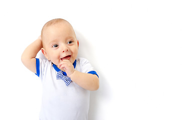 Image showing baby boy lying on white floor